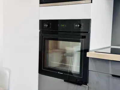 a kitchen with a black oven in a kitchen at L'impérator - Petit Juas Cannes in Cannes