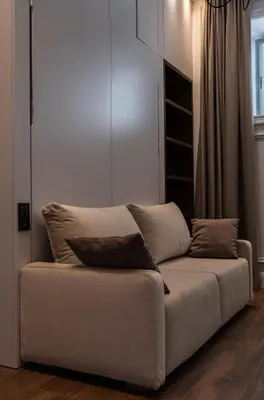 a white couch in a living room with a window at Apartments in the heart of Cannes in Cannes