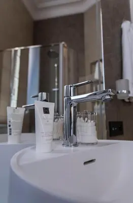 a bathroom sink with a faucet and a mirror at Apartments in the heart of Cannes in Cannes