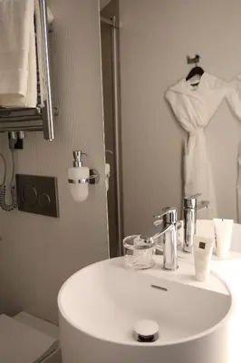 a bathroom with a white sink and a mirror at Apartments in the heart of Cannes in Cannes