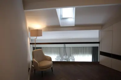 a living room with a chair and a window at Apartments in the heart of Cannes in Cannes