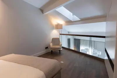 a bedroom with a bed and a chair and a window at Apartments in the heart of Cannes in Cannes