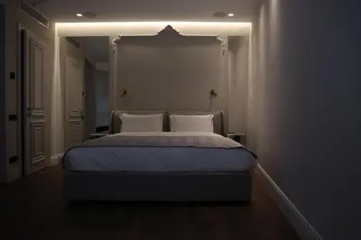 a bedroom with a bed in a dark room at Apartments in the heart of Cannes in Cannes