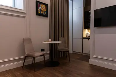 a room with a table and two chairs and a tv at Apartments in the heart of Cannes in Cannes