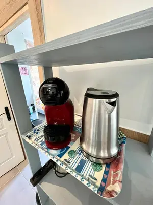 a coffee maker on a shelf in a kitchen at Appartement 3 pièces GREEN ART **** in Le Cannet