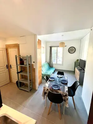 a living room with a table and chairs at Appartement 3 pièces GREEN ART **** in Le Cannet
