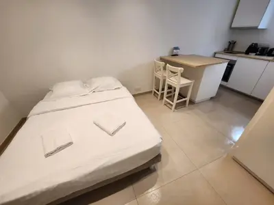 a small room with a bed and a kitchen at C073-Studio neuf et lumineux au carre d'or Croisette in Cannes