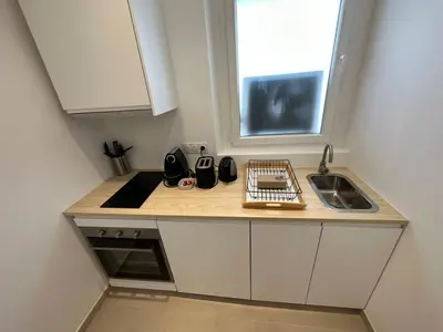 a small kitchen with a sink and a window at C073-Studio neuf et lumineux au carre d'or Croisette in Cannes