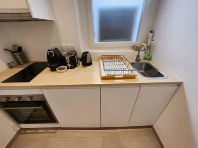a small kitchen with a sink and a counter at C073-Studio neuf et lumineux au carre d'or Croisette in Cannes