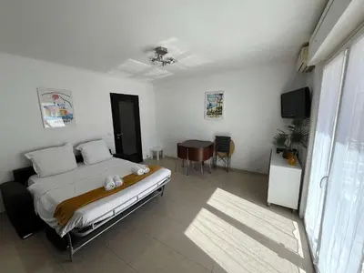 a bedroom with a bed and a table in it at C067-Beau Studio a 100 m des plages et proche Palais in Cannes