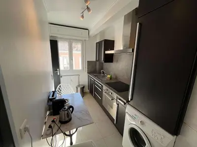 a kitchen with a black refrigerator and a dishwasher at C067-Beau Studio a 100 m des plages et proche Palais in Cannes
