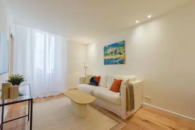 a living room with a couch and a table at Upscale 1-Br apartment 100 meter from the Palais des Festivals in Cannes