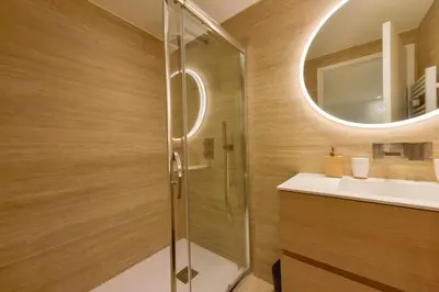 a bathroom with a shower and a sink and a mirror at Upscale 1-Br apartment 100 meter from the Palais des Festivals in Cannes