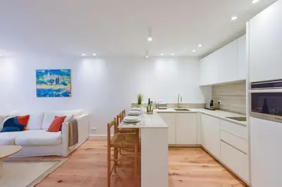 a kitchen and living room with a couch and a table at Upscale 1-Br apartment 100 meter from the Palais des Festivals in Cannes
