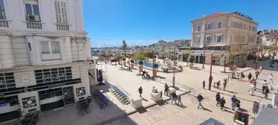 a group of people walking on a city street at M.M.R. Gioma in Cannes