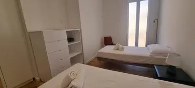 a small white room with two beds and a window at M.M.R. Gioma in Cannes