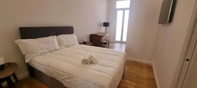 a bedroom with a bed with a pair of shoes on it at M.M.R. Gioma in Cannes