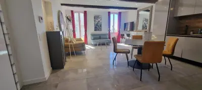 a kitchen and dining room with a table and chairs at M.M.R. Gioma in Cannes