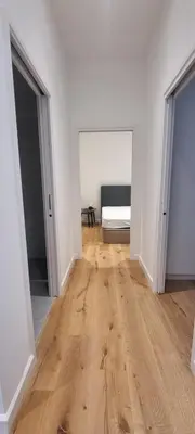 an empty room with a bed and a wooden floor at M.M.R. Gioma in Cannes