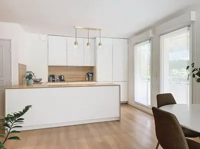 a kitchen with a white counter and a table at Agencia Superbe appartement 2 chambres in Cannes