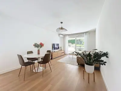 a white living room with a table and chairs at Agencia Superbe appartement 2 chambres in Cannes