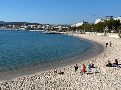 a group of people on a beach near the water at Grand 2 pieces- Marche Forville in Cannes