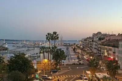 a city street with palm trees and a harbor at Grand 2 pieces- Marche Forville in Cannes