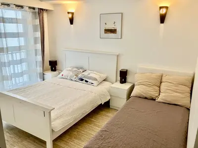 a bedroom with two beds and a window at Grand 2 pieces- Marche Forville in Cannes