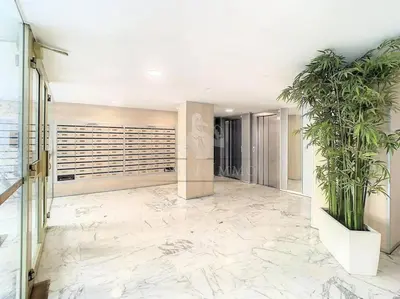 a hallway with marble floors and plants in a building at Grand 2 pieces- Marche Forville in Cannes