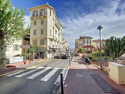 a city street with a white building on the side of the road at Grand 2 pieces- Marche Forville in Cannes