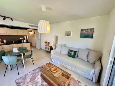 a living room with a couch and a table at B035 Magnifique appartement neuf a deux pas du centre in Cannes