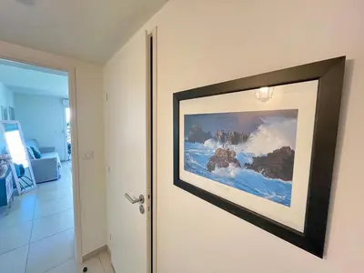 a picture hanging on a wall next to a door at B035 Magnifique appartement neuf a deux pas du centre in Cannes