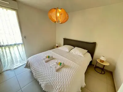 a bedroom with a bed with two trays on it at B035 Magnifique appartement neuf a deux pas du centre in Cannes