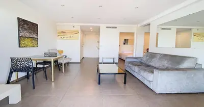 a living room with a couch and a table at Le Croisette - 4 pers - Front de mer - 15 min Palais in Cannes