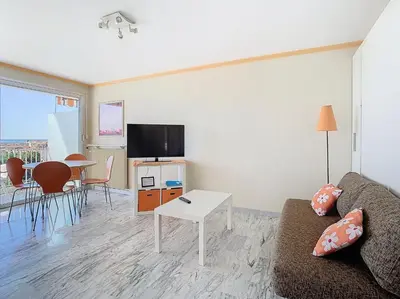 a living room with a couch and a table at Le Montfleury - Studio 28m2 - Vue mer - Centre in Cannes