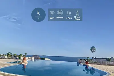 a swimming pool with a view of the ocean at Le Francia - T2 30m2 - Piscine - Vue mer in Cannes