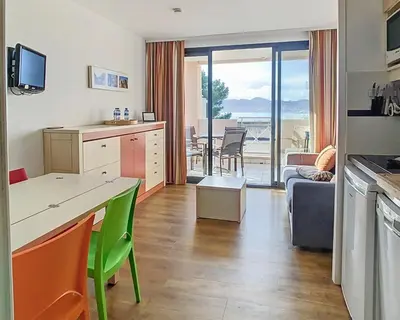 a kitchen and living room with a view of the ocean at Le Francia - T2 30m2 - Piscine - Vue mer in Cannes