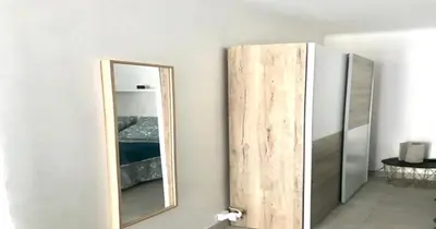 a mirror on a wall next to a refrigerator at Le Palladium - Studio - 10mn Palais - Climatisé in Cannes