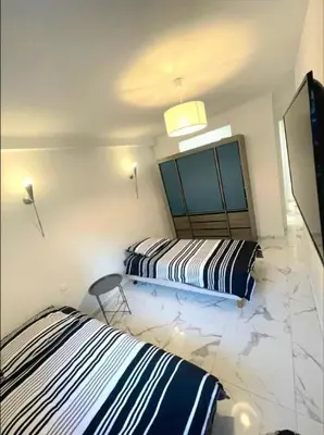 a bedroom with two beds and a tv in it at Evasion Cannoise in Cannes