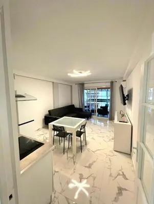 a kitchen and living room with a table and chairs at Evasion Cannoise in Cannes