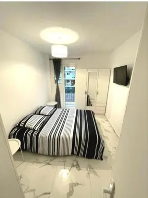 a bedroom with a black and white bed and a staircase at Evasion Cannoise in Cannes