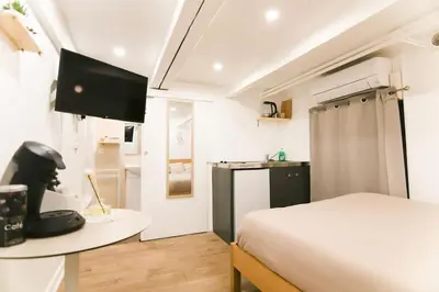 a bedroom with a bed and a desk with a computer at Studio palais des festivals Croisette in Cannes