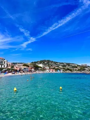 a group of people in the water at a beach at Studio palais des festivals Croisette in Cannes