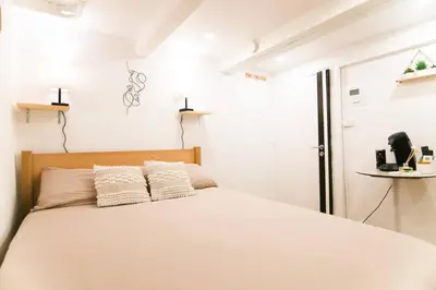 a bedroom with a white bed with two pillows at Studio palais des festivals Croisette in Cannes
