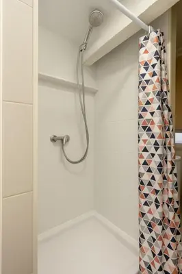 a shower in a bathroom with a shower curtain at Studio palais des festivals Croisette in Cannes