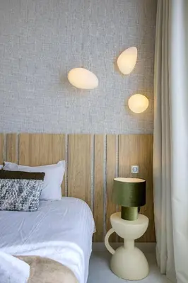 a bedroom with a bed and three lights on the wall at Jessicannes - ALBA - Plage et Palais des Festival à pied in Cannes