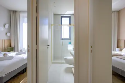 a bathroom with a sink and a toilet in a bedroom at Jessicannes - ALBA - Plage et Palais des Festival à pied in Cannes