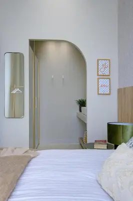 a bedroom with a large white bed with a mirror at Jessicannes - ALBA - Plage et Palais des Festival à pied in Cannes