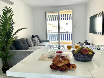 a living room with a table with a bowl of bread at Superbe appartement à Cannes / 3 chambres in Cannes