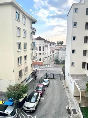 a group of cars parked in a parking lot next to buildings at Superbe appartement à Cannes / 3 chambres in Cannes